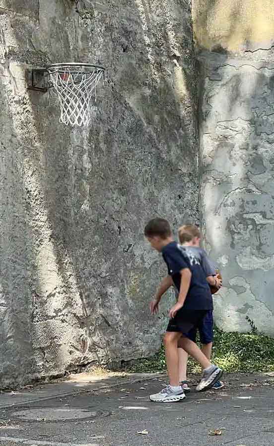 Zwei Jungen spielen mit einem Ball unter einem Basketballkorb im Kinderhaus Dorothea von Flühe in Konstanz